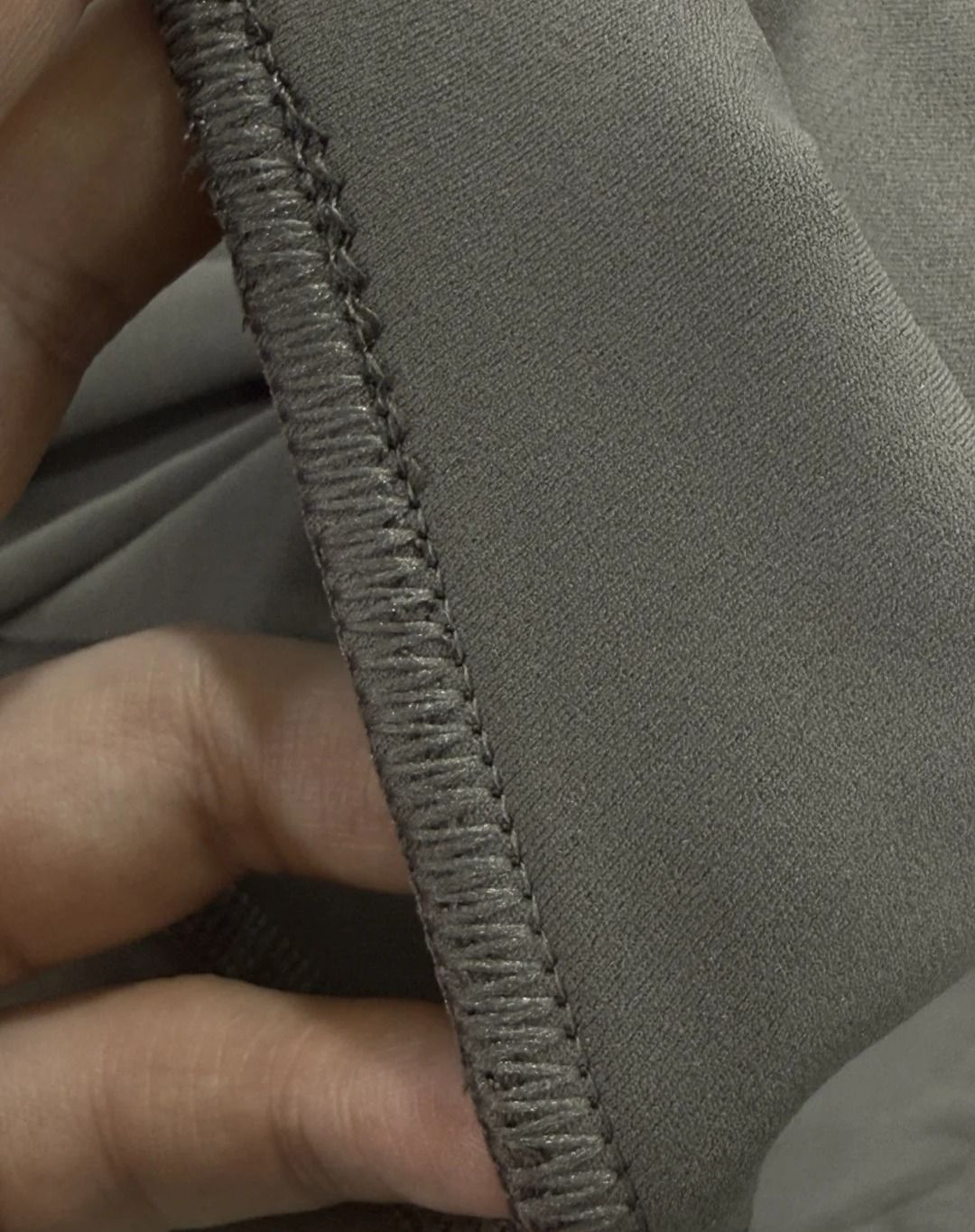 Close view of a flatlock seam and a gusseted panel on training joggers
